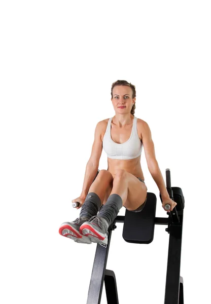 Athletic young woman training press on exerciser — Stock Photo, Image