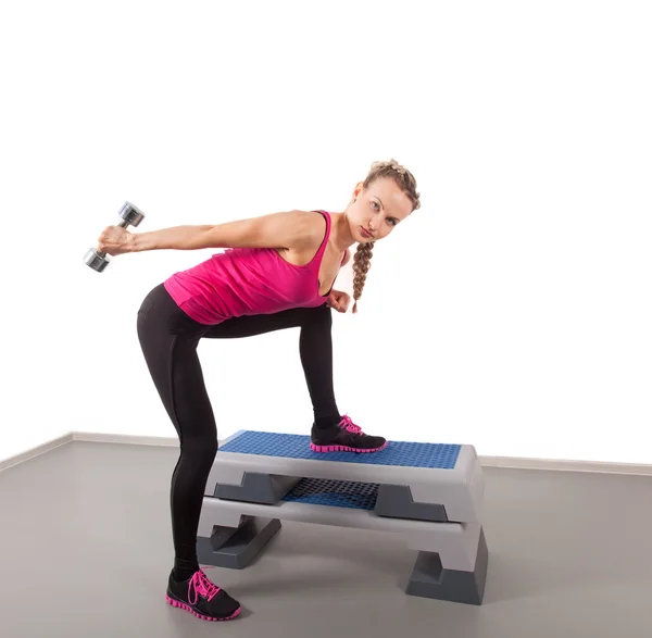 Athletic young woman training with dumbbell — Stock Photo, Image