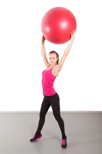 Atletisk ung kvinna med röd boll — Stockfoto