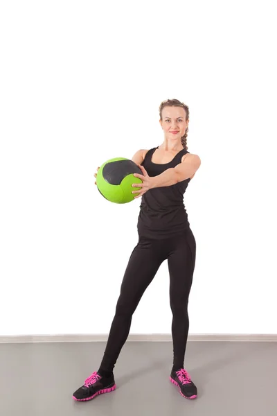 Athletic young woman training with green ball — Stock Photo, Image