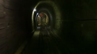 Moving funicular in subway tunnel, cabin view