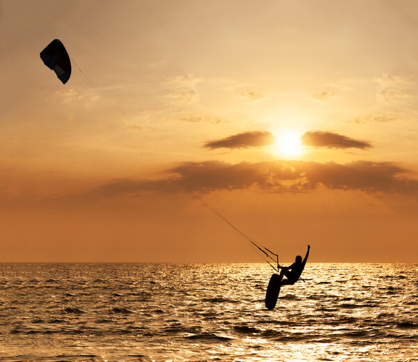 Kite surfer jumping from the water