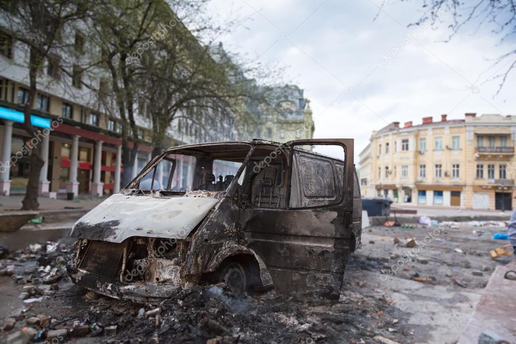 Burned car in the center of city after unrest