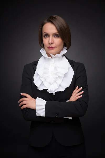 Business woman on dark grey background — Stock Photo, Image