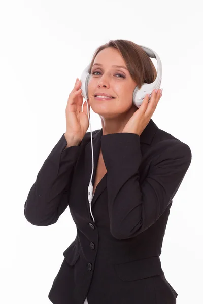Businesswoman with earphones on white — Stock Photo, Image