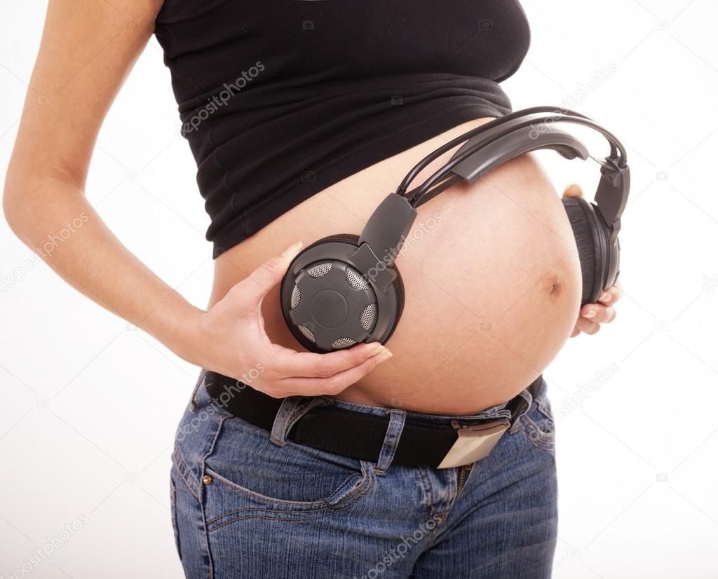 Belly pregnant woman with headphones Stock Photo by ©svyatoslavlipik  34774629