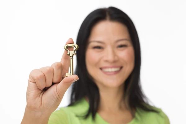 Asian woman hold old key on white Stock Picture