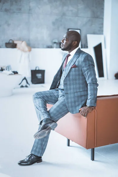 Secured Successful Businessman in Stylish Formal Suit Sits on the Back of the Sofa Cross-legged in his Apartment. Big Boss in the Central Office. Close-up — Stock Photo, Image