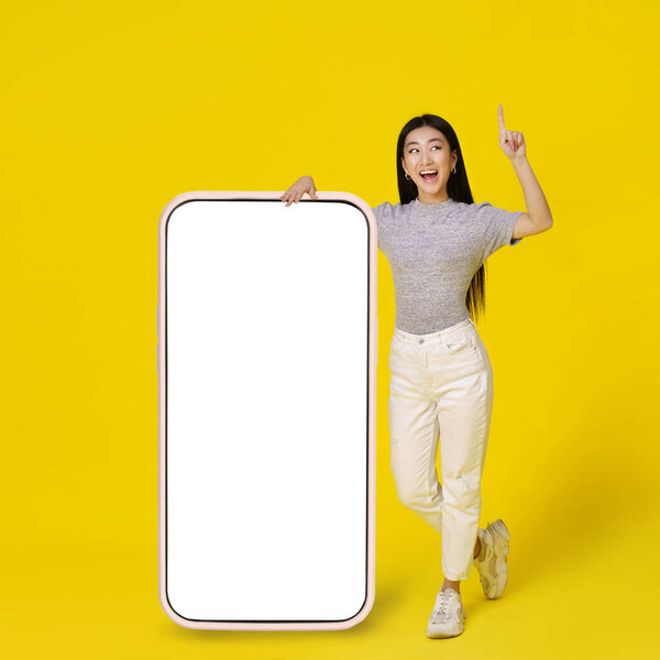 Happy Asian Girl Leaned Giant Huge Smartphone White Blank Screen Royalty Free Stock Photos