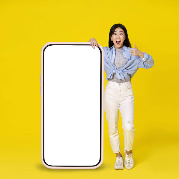 Excited Asian Girl Gesturing Thumb Leaned Giant Huge Smartphone White Stock Photo