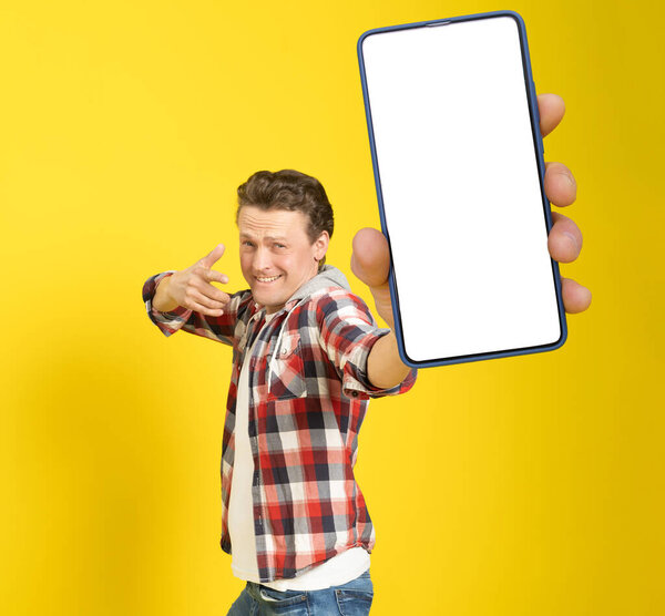 Happy Win Handsome Man Pointing Smartphone White Empty Screen Wearing Stock Image