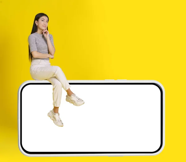 Ragazza Asiatica Premuroso Sedersi Smartphone Enorme Con Schermo Bianco Indossando — Foto Stock