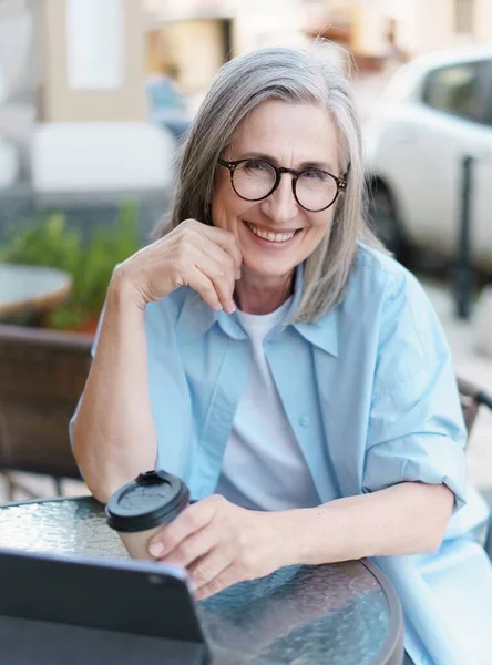 European Gray Haired Mature Woman Drinks Coffee While Surf Internet — 图库照片