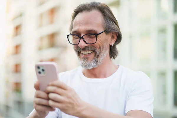 Happy Caucasian Middle Aged Man Grey Beard Reading Texting Using — Stok fotoğraf