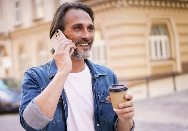 Happy Middle Aged Man Grey Bearded Talking Phone Holding Coffee — 스톡 사진
