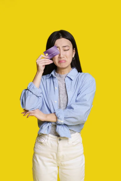Sad Unhappy Asian Girl Cover Her Bank Card Right Eye — Fotografia de Stock