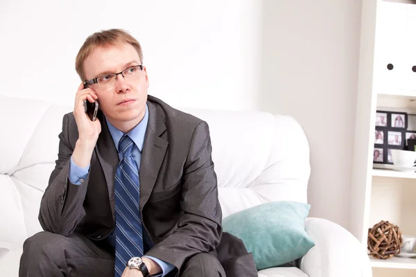 Man sitting on sofa — Stock Photo, Image