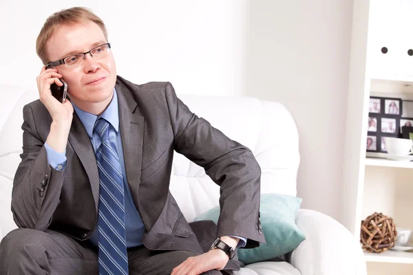 Man sitting on sofa — Stock Photo, Image