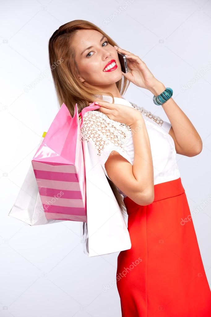 Woman with shopping bags talking on mobile