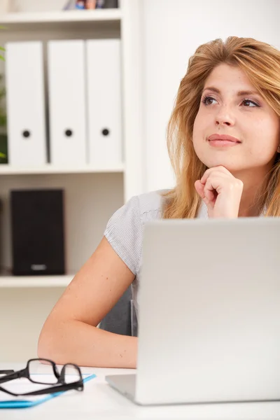 Woman sitting at desk Stock Picture