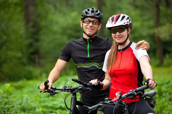 Man and woman ride bike — Stock Photo, Image
