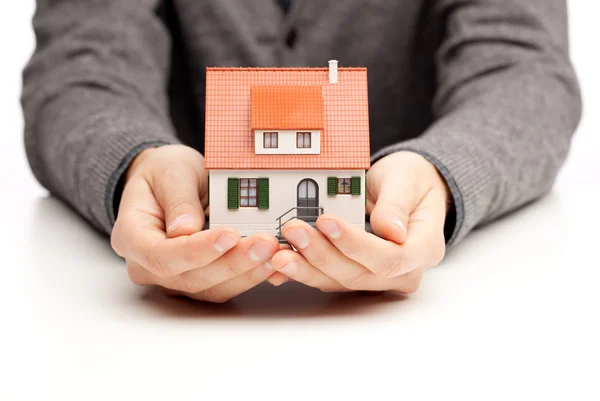 Hands holding a small house — Stock Photo, Image