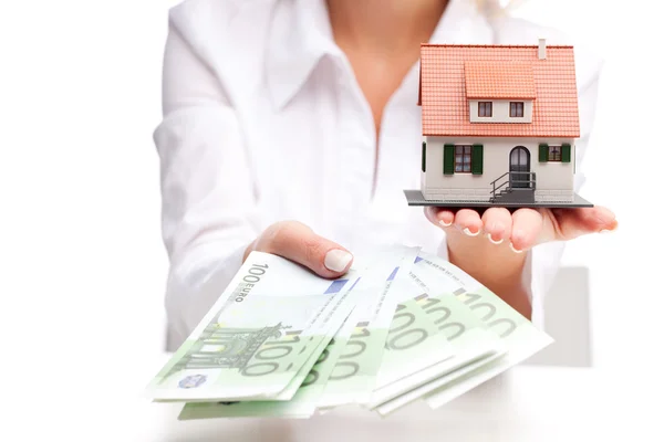 Little house toy and money in woman's hands — Stock Photo, Image