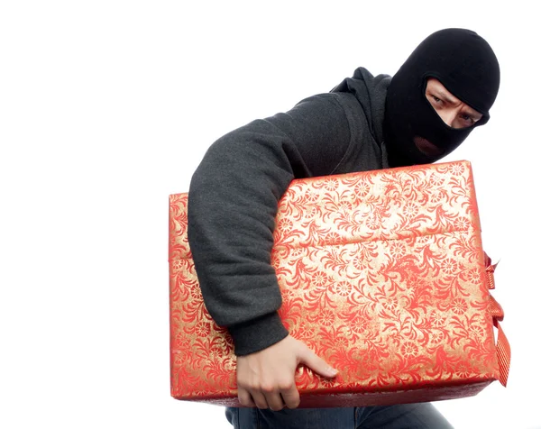 Bandit holding a wrapped Christmas gift — Stock Photo, Image