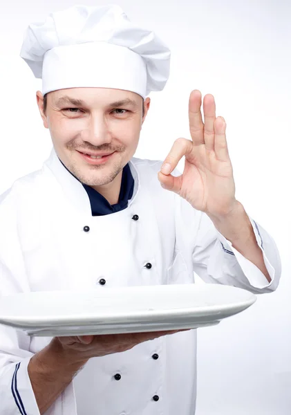 Chef holding empty plate — Stock Photo, Image