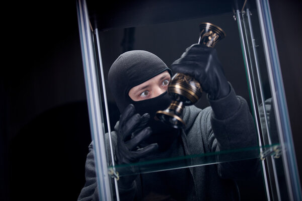 Burglar wearing black mask