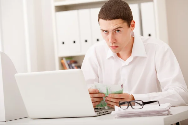 Man with laptop and money — Stock Photo, Image