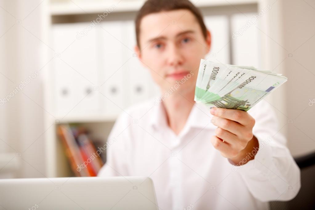 Man with Euro in office