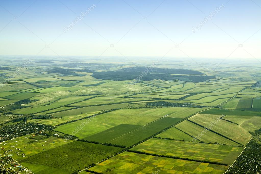 Aerial view of a green rural area under blue sky — Stock Photo
