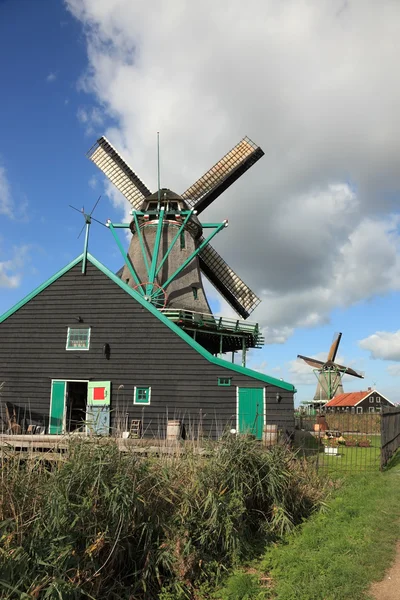 Windmill and barn on a green hill — Stock Photo, Image