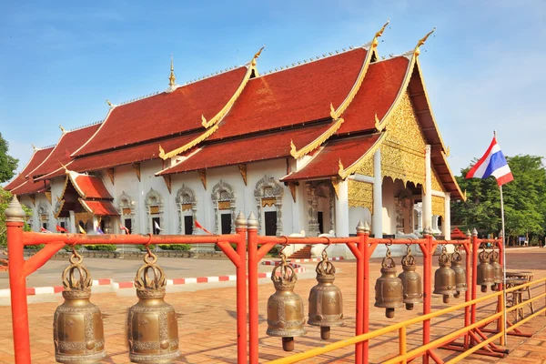 Fencing of the temple is decorated with bronze bells — Stock Photo, Image