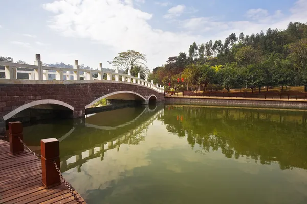 A grande piscina e a ponte perto do hotel na cidade chinesa — Fotografia de Stock