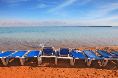 turistler için bekleyen mavi plaj sandalyeleri