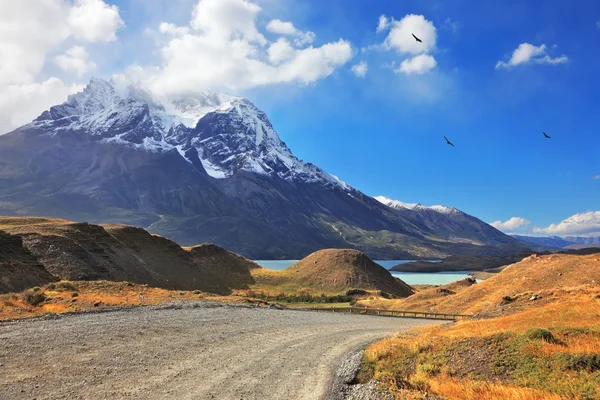 Snow-capped mountain peaks and road — Stock Photo, Image