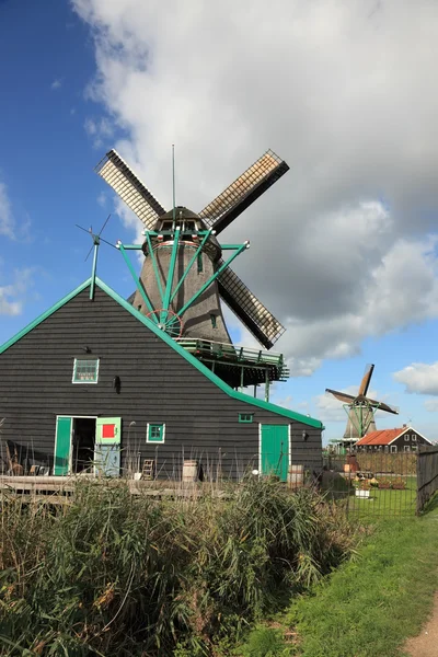 Větrný mlýn a stodola na zeleném kopci — Stock fotografie