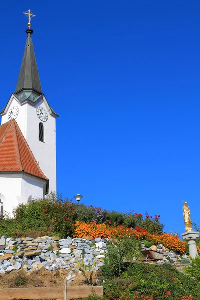 Church  surrounded by flowers — Stock Photo, Image