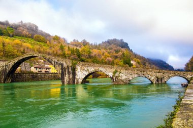 Italy, province of Lucca, region of Tuscany. The Bridge of Mary Magdalene in Borgo a Mozzano is an impressive medieval structure that crosses the Serchio River. 