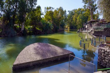 The Jordan River. Yardenit, Israel. Fine warm sunny February day. The place of the symbolic ceremony of baptism. Religious and photo tourism concept