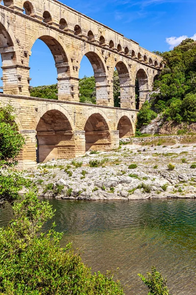 Masterpiece of ancient Roman architecture on the shallow Gardon River. The Pont du Gard is the tallest Roman aqueduct. The aqueduct is a three-tiered arcade of yellow-pinkish limestone.