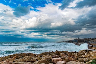 Huge waves crash against the rocks. Stormy Mediterranean Sea off the coast of the old port of Tel Aviv. Magnificent storm. 