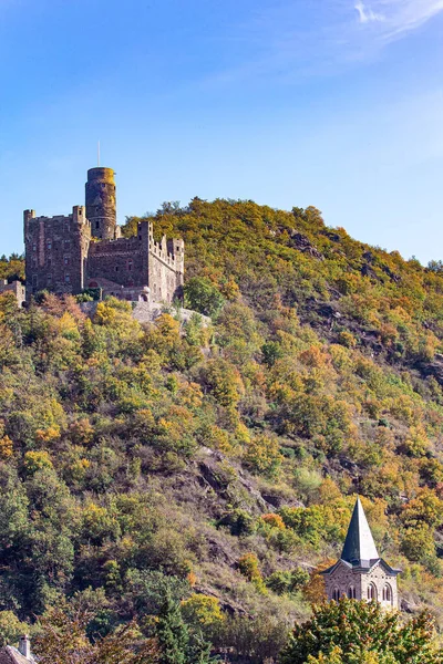 Scenic Castle Mouse. Steep wooded banks of the great river Rhine. Medieval romantic castles and ruins. Warm autumn in Germany