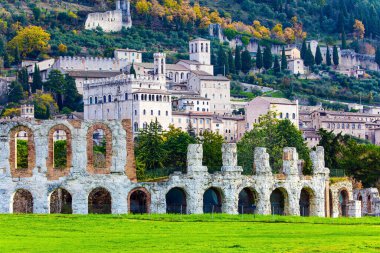 Roman amphitheater built two thousand years ago. Magnificent Renaissance palace. The city of Gubbio in the Umbrian mountains. Winter cold and windy day. Italy. 