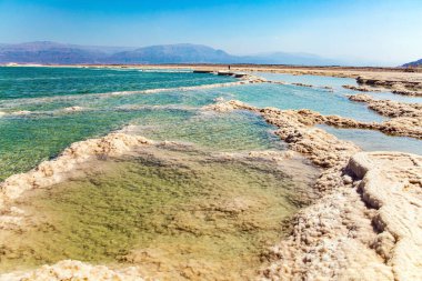 Dead Sea. The drainless salt lake in the Middle East, the saltiest lake in the world. On the surface of the water, the evaporated salt forms bizarre crystal shapes