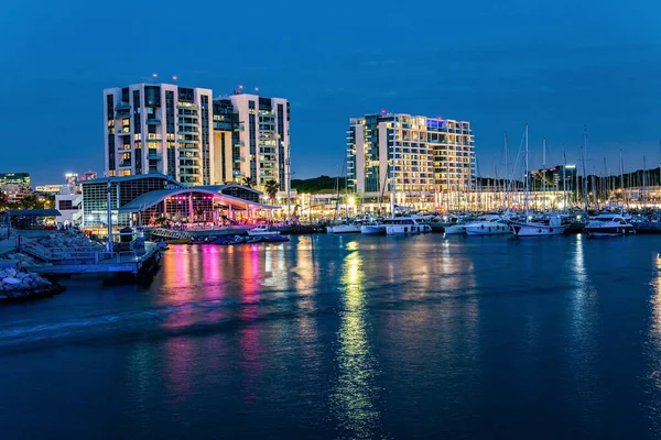 Marina is a harbor for yachts, boats and small boats in Herzliya, Israel. Evening twilight on the Mediterranean Sea. Walk along the breakwater that protects the yacht harbor from storms. 