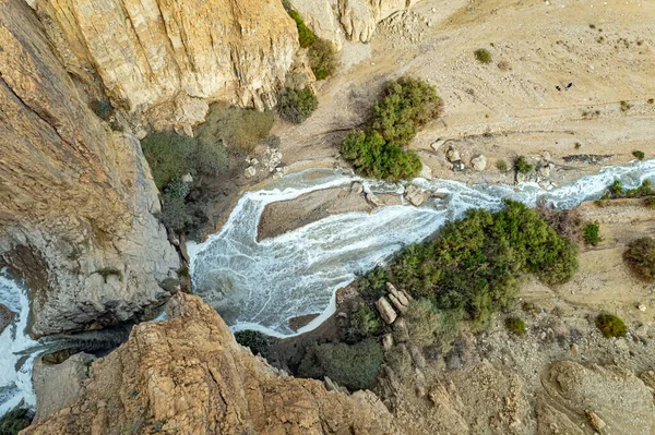 The waterfall and a small lake were photographed by a drone. Cold rainy winter in Israel. Winter flood on the Kidron stream. Dead Sea. The famous biblical stream Kidron. Walking on a cloudy weekend