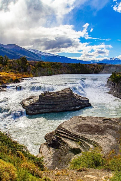 Incredible stunning landscape. The stormy Peine River is blocked by giant granite rocks that form the Peine Cascades. Chile, South America. Torres del Paine Park. 
